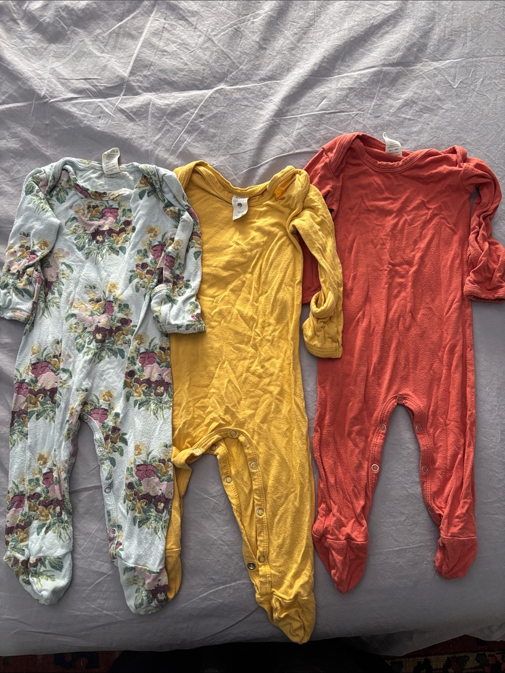 Kate Quinn footed onesies (3 total)